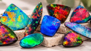 Collection of Australian black and boulder opals displaying vibrant colours including blue, green, red and orange