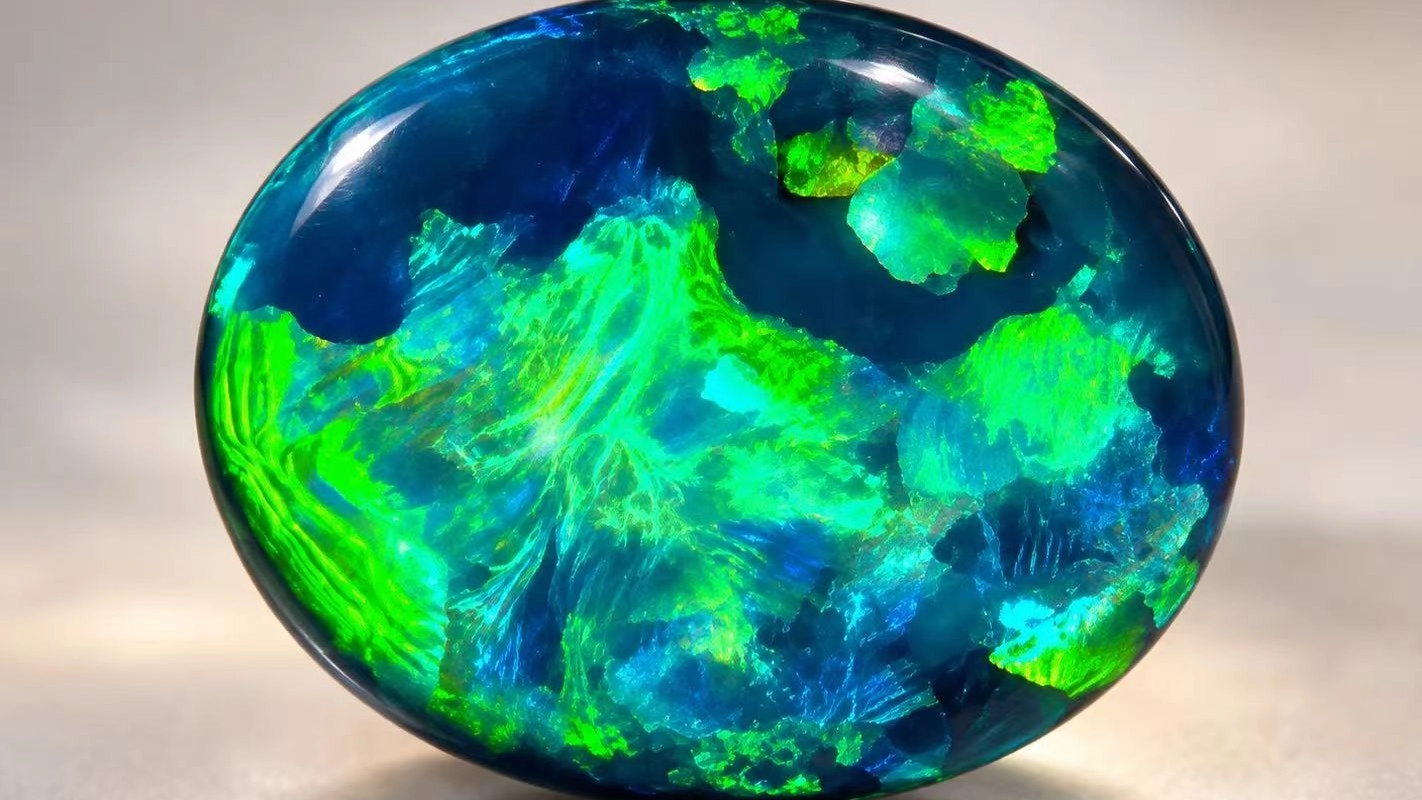 Close-up of an Australian black opal displaying vivid blue and green play-of-colour