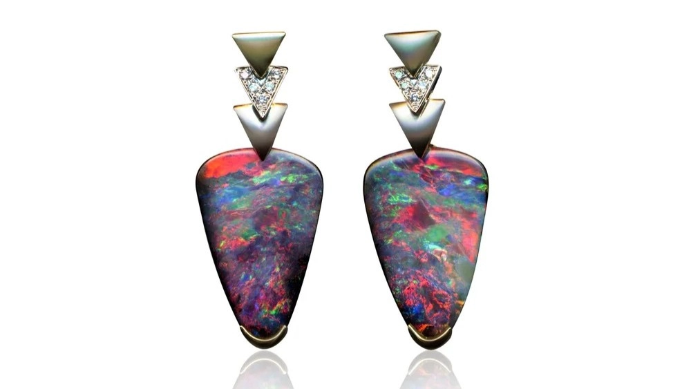 Pair of Australian black opal earrings displaying vibrant red, blue, green and purple colours